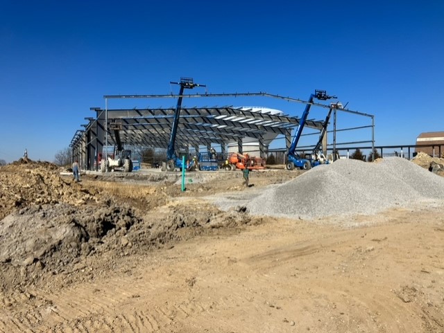Large commercial steel-erection job by Parker Welding showing red-iron frame going up
